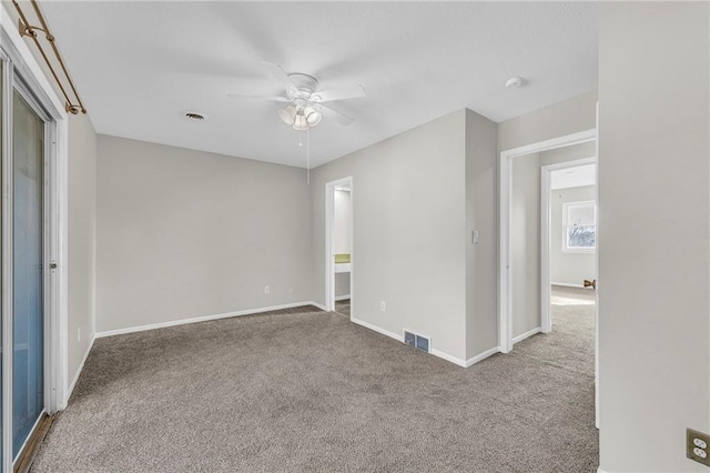 interior space with carpet floors, visible vents, and baseboards