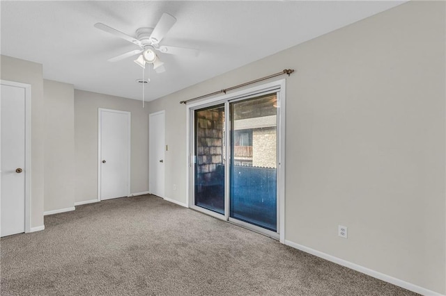 unfurnished room featuring carpet, a ceiling fan, and baseboards