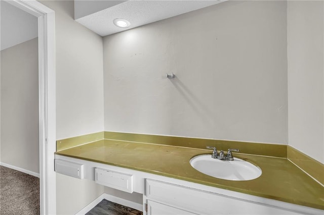 bathroom with recessed lighting, a sink, and a textured ceiling