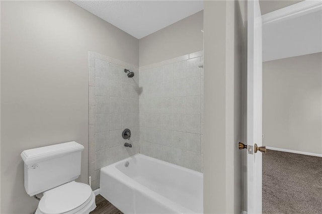 bathroom with  shower combination, toilet, and baseboards