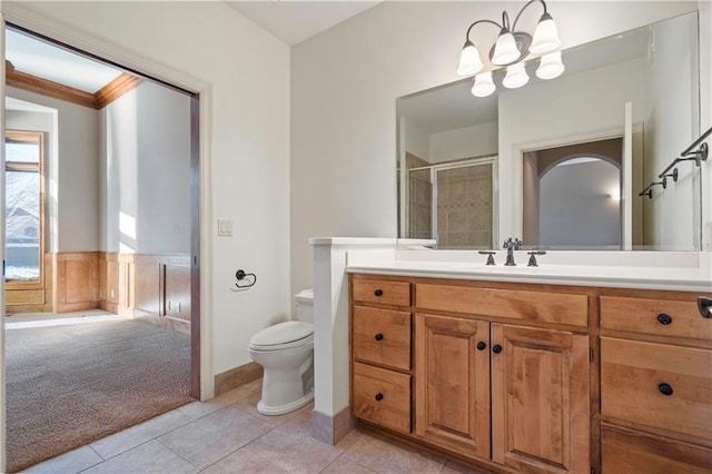 full bath with toilet, a notable chandelier, vanity, tiled shower, and tile patterned floors