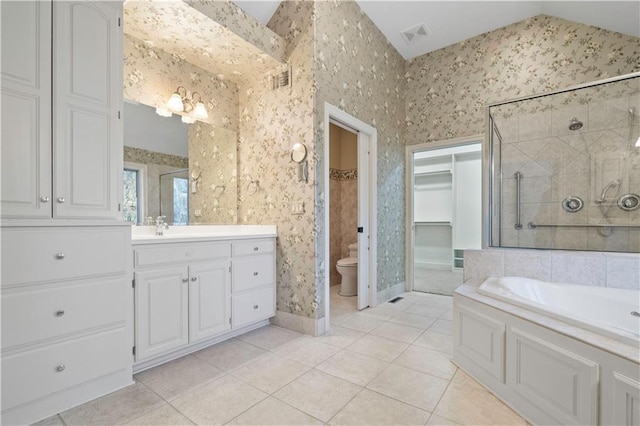 full bath featuring wallpapered walls, a stall shower, lofted ceiling, toilet, and tile patterned flooring