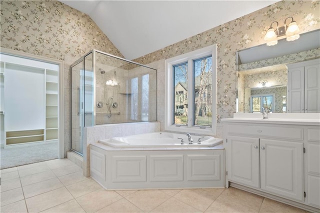 full bath with a stall shower, lofted ceiling, a garden tub, and wallpapered walls