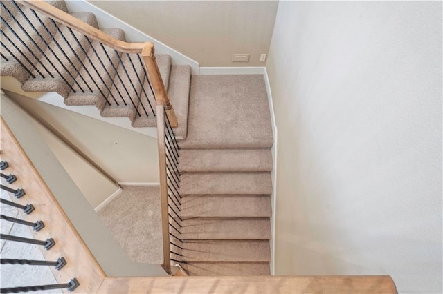 stairs featuring carpet floors and baseboards