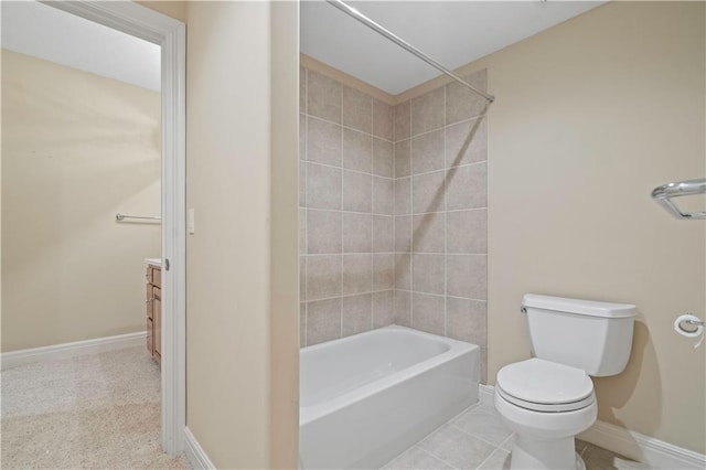 full bathroom with shower / bathtub combination, toilet, vanity, baseboards, and tile patterned floors