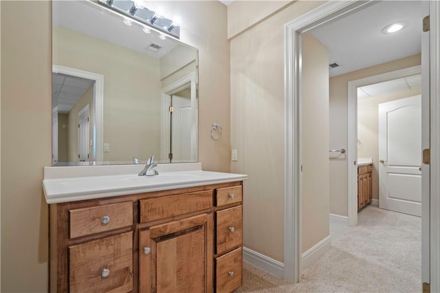 bathroom featuring visible vents, vanity, and baseboards