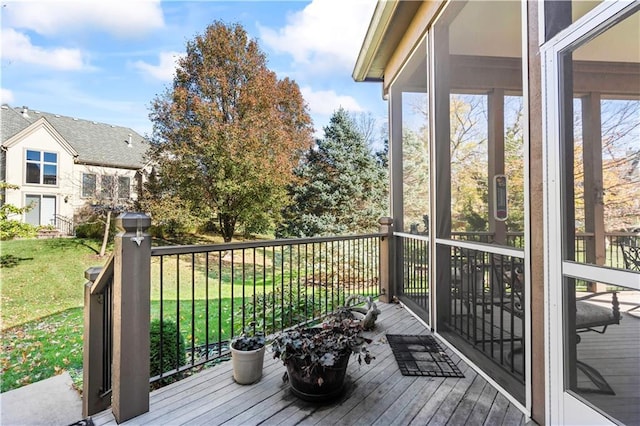 wooden terrace featuring a lawn