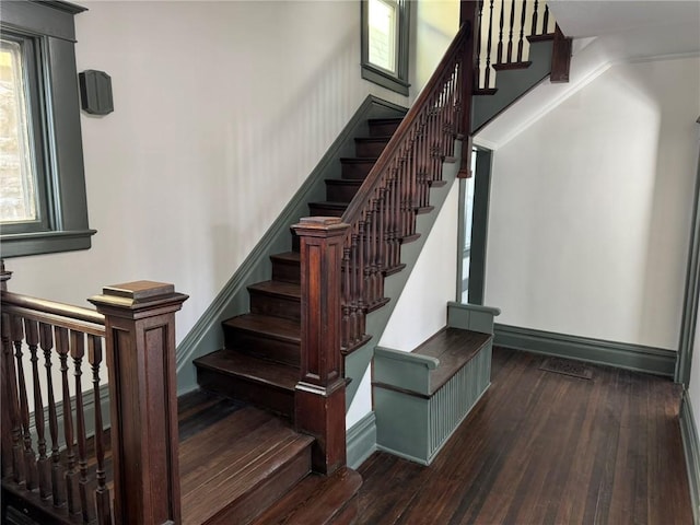 stairs with hardwood / wood-style floors and baseboards