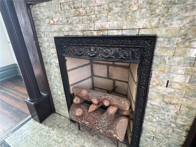 details featuring a fireplace and wood finished floors