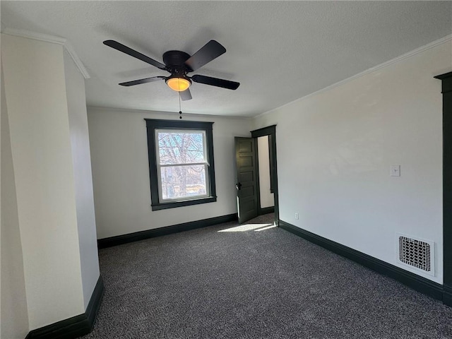 unfurnished room featuring baseboards, visible vents, dark colored carpet, and ornamental molding