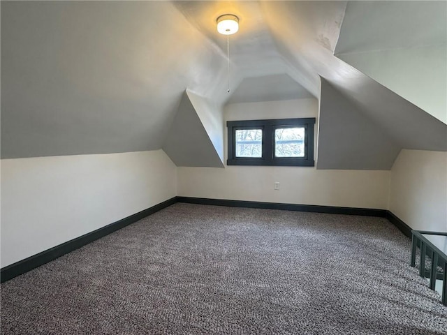 bonus room with carpet floors, lofted ceiling, and baseboards