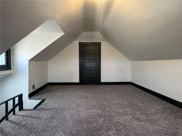 bonus room featuring carpet floors, visible vents, baseboards, and vaulted ceiling