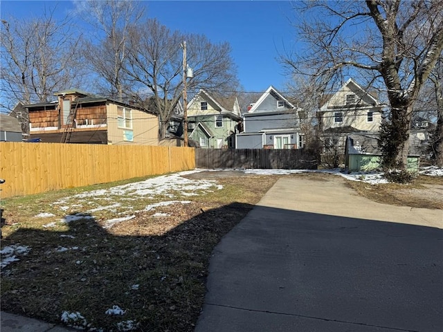 view of yard featuring fence and a residential view