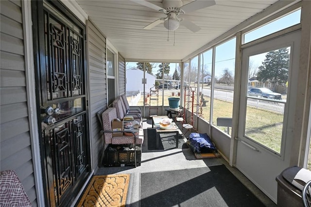 sunroom / solarium featuring plenty of natural light and a ceiling fan