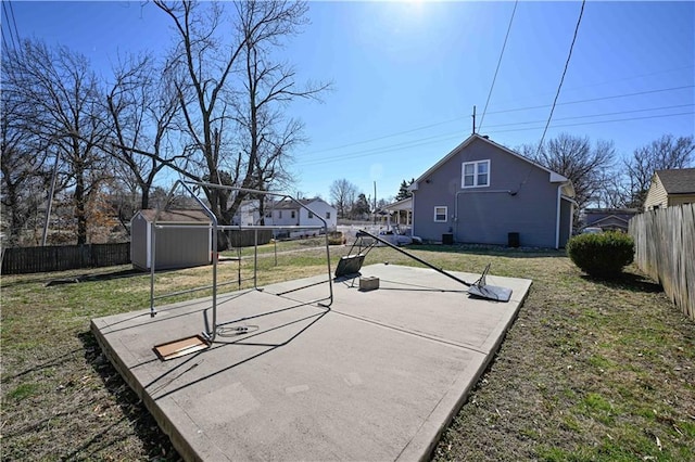 exterior space with an outdoor structure, a storage shed, and a fenced backyard