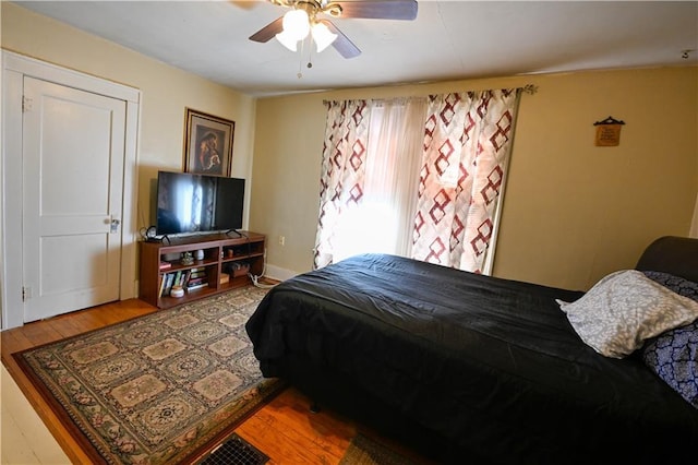 bedroom with ceiling fan and wood finished floors