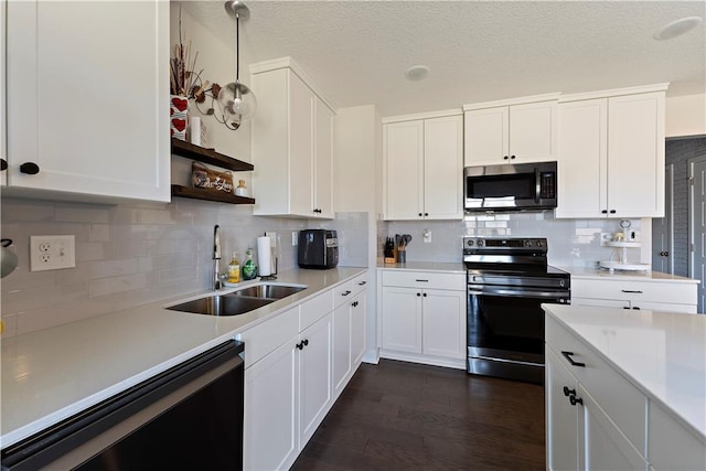 kitchen featuring dishwashing machine, electric range, a sink, light countertops, and stainless steel microwave