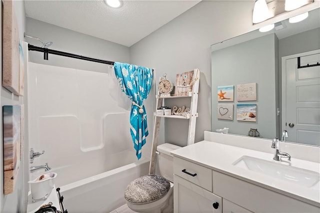 bathroom with a textured ceiling, vanity, shower / tub combo, and toilet