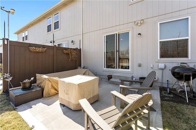 view of patio with grilling area and fence