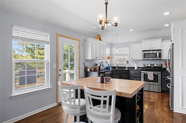 kitchen featuring a sink, white cabinetry, appliances with stainless steel finishes, wooden counters, and dark wood-style flooring