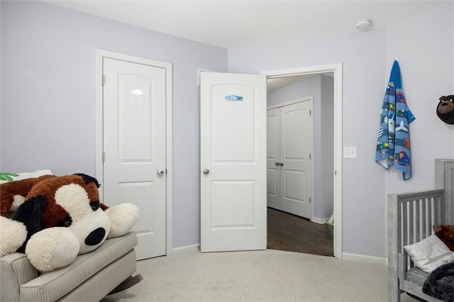 bedroom featuring baseboards and carpet flooring