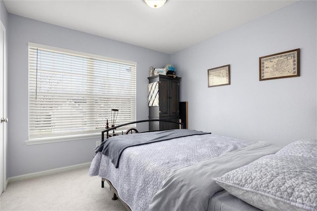 bedroom featuring baseboards and carpet floors