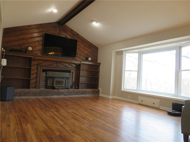 24243 Sandusky Rd, Tonganoxie, KS 66086 - unfurnished living room featuring wood finished floors, baseboards, wood walls, and a fireplace