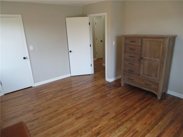 24243 Sandusky Rd, Tonganoxie, KS 66086 - unfurnished bedroom with wood finished floors and baseboards