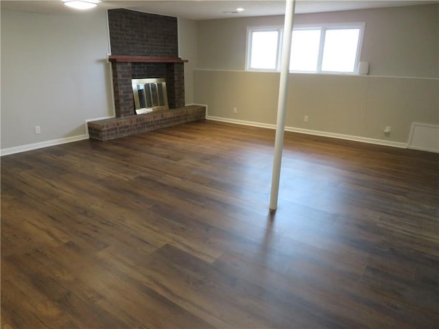 24243 Sandusky Rd, Tonganoxie, KS 66086 - below grade area featuring baseboards, dark wood-type flooring, and a fireplace