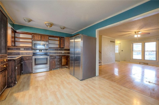 kitchen featuring appliances with stainless steel finishes, ornamental molding, a textured ceiling, light wood-type flooring, and open shelves