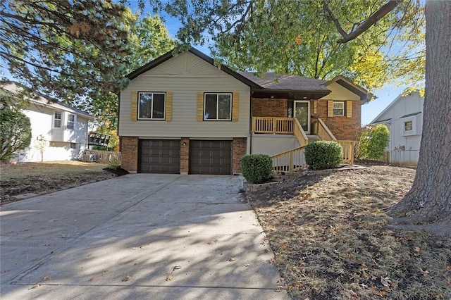 view of front of house featuring driveway, brick siding, and an attached garage