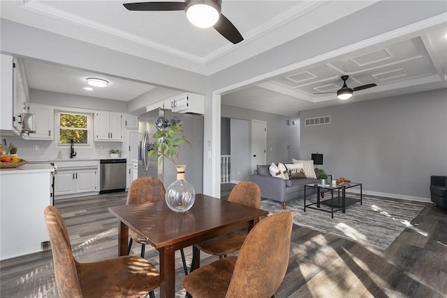 dining area featuring visible vents, baseboards, a ceiling fan, dark wood-style floors, and crown molding