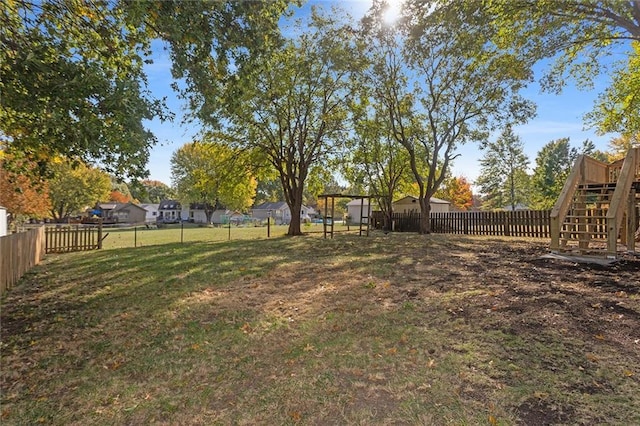 view of yard with a fenced backyard and stairs