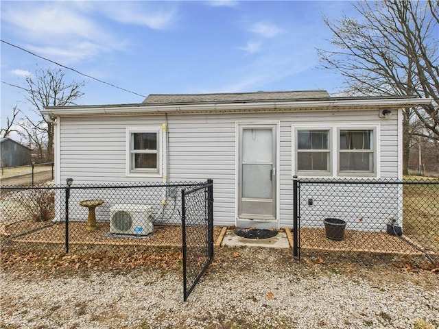 back of house with roof with shingles and fence