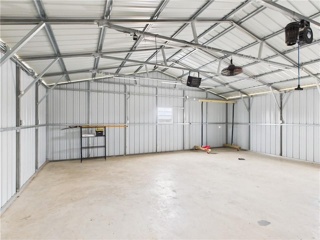 garage featuring a garage door opener and metal wall