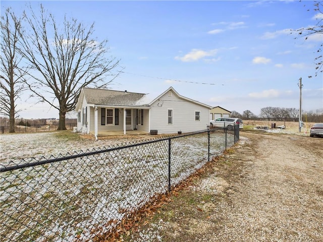 rear view of property featuring a fenced front yard