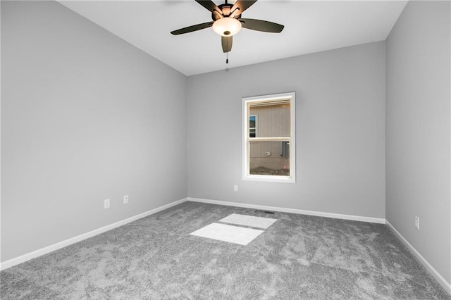 empty room with carpet, ceiling fan, and baseboards