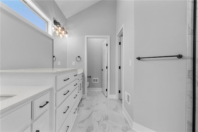 bathroom featuring marble finish floor, visible vents, toilet, vaulted ceiling, and vanity