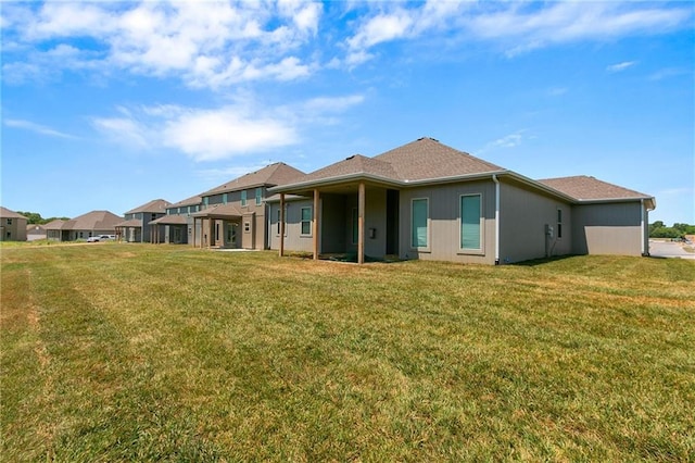 rear view of property with a lawn