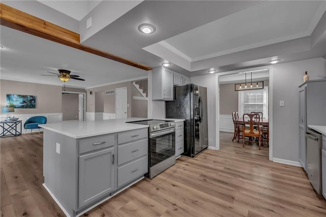 kitchen with stainless steel appliances, gray cabinetry, ornamental molding, and light wood finished floors