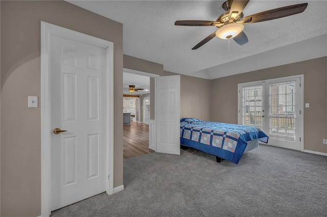 carpeted bedroom featuring a textured ceiling, french doors, baseboards, lofted ceiling, and access to exterior