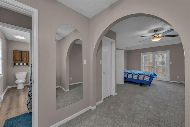 unfurnished bedroom with access to exterior, ceiling fan, baseboards, french doors, and a textured ceiling