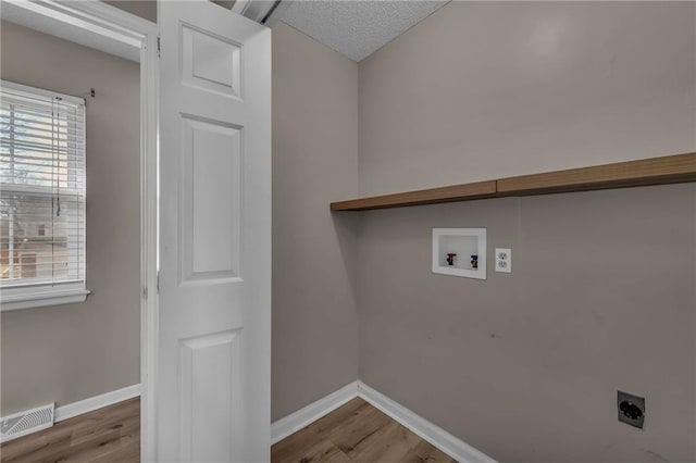 laundry area featuring visible vents, baseboards, hookup for an electric dryer, and washer hookup