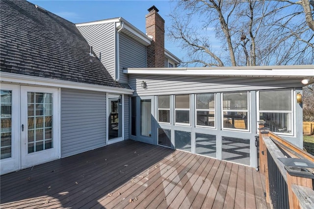 wooden terrace featuring french doors and a sunroom