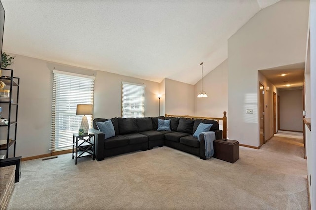 living room with a textured ceiling, baseboards, a chandelier, and light carpet