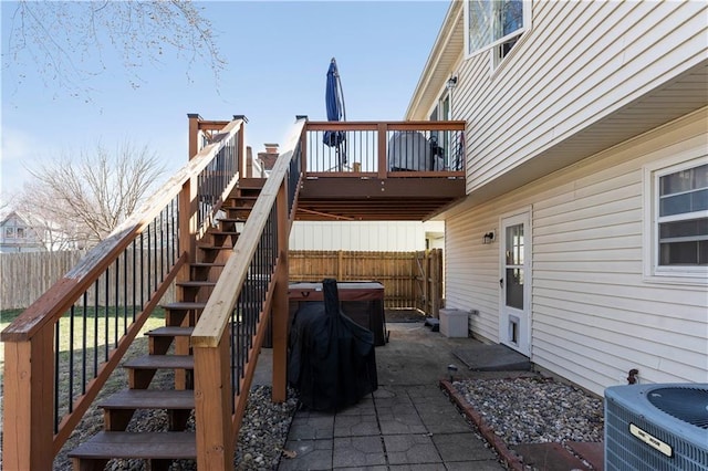 exterior space with stairway, central AC unit, a wooden deck, and fence