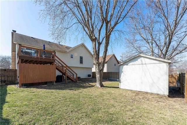 rear view of property with a shed, stairs, a fenced backyard, a deck, and an outbuilding