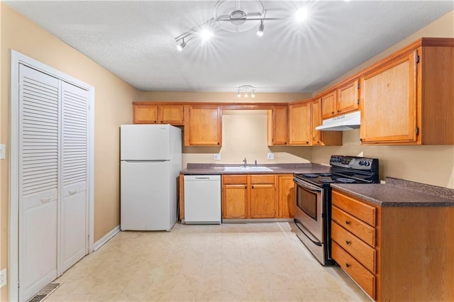 6418 E 150th St, Grandview, MO 64030 - kitchen featuring white appliances, under cabinet range hood, a sink, and dark countertops