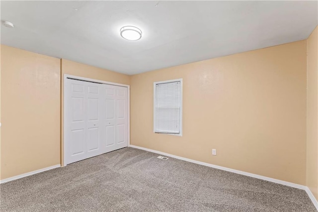 6418 E 150th St, Grandview, MO 64030 - unfurnished bedroom featuring carpet flooring, baseboards, and a closet