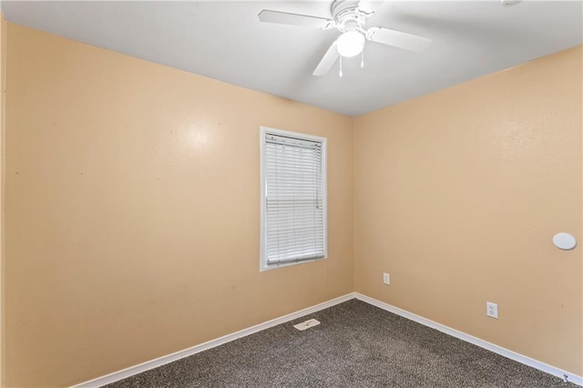 6418 E 150th St, Grandview, MO 64030 - spare room with baseboards, dark colored carpet, and a ceiling fan